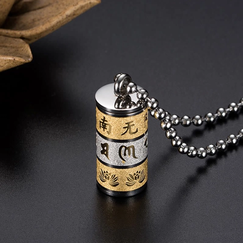 Sealed titanium steel prayer wheel pendant with screw-on cap and multi-tone engraved Buddhist design