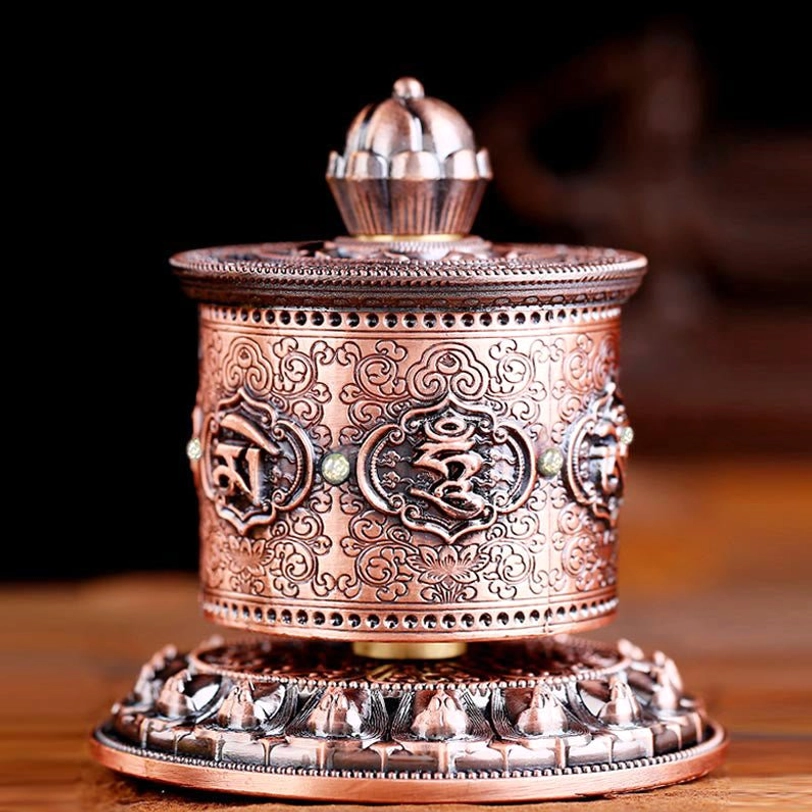 Red Tibetan prayer wheel car hanging featuring embossed Om Mani Padme Hum and lotus engraving details