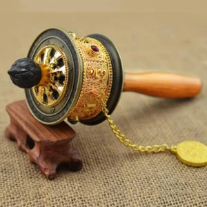 Handcrafted Tibetan prayer wheel three-quarter side view showing carved floral motifs and metal details on wooden stand