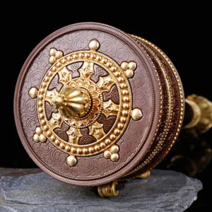 Prayer wheel top view showing Dharma wheel center and carved lotus base