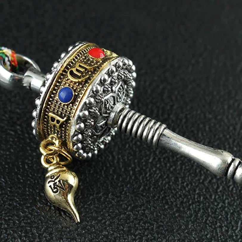 Tibetan prayer wheel hanging accessory with vajra design and endless knot charm for spiritual protection and meditation