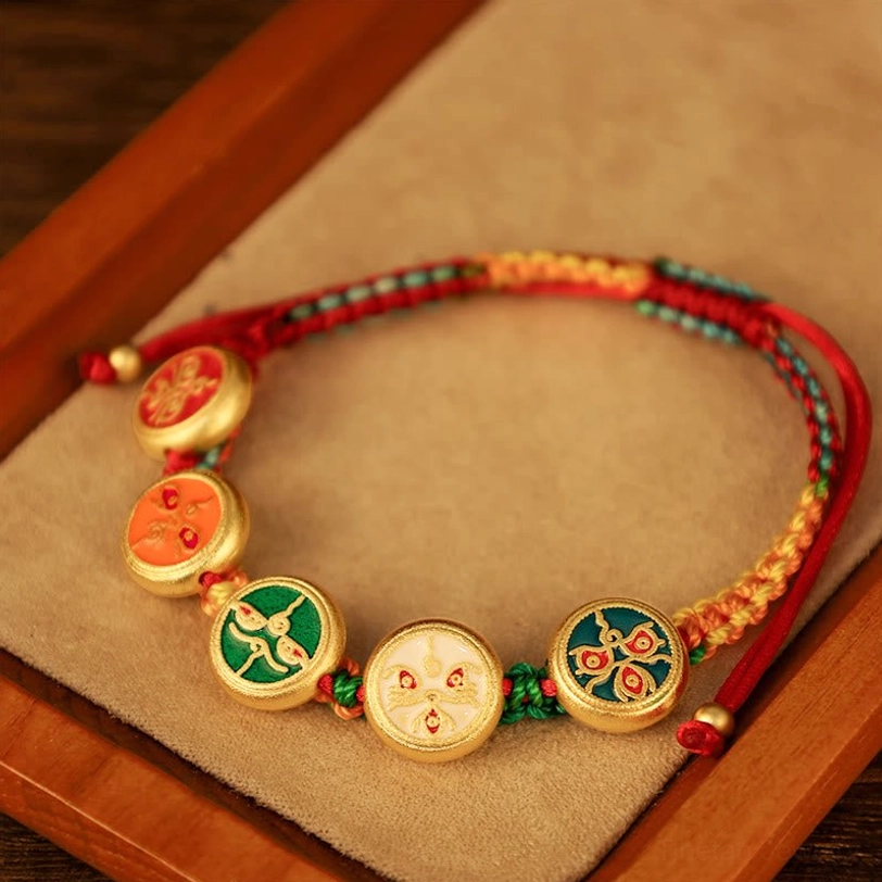 Tibetan prosperity bracelet with woven multicolor braided rope and five enamel Buddhist deity medallions showing adjustable knot design