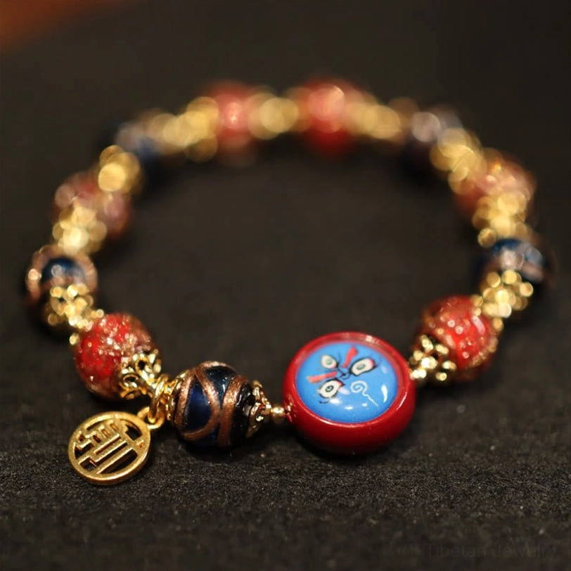 Tibetan prosperity bracelet with enamel face motif bead, fortune tag charm and glossy mixed stone beads flat lay