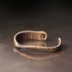 Open cuff bracelet top-down flat lay showing twisted wire surface texture and rounded open terminals