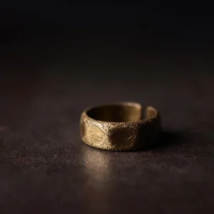 Adjustable open cuff copper prosperity ring - three-quarter side view displaying hammered frosted texture and minimalist design