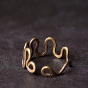 Open-ended wavy brass ring side angle showing curved wave design and adjustable fit