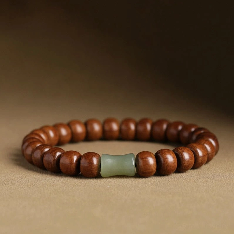 Tibetan Abelia Biflora wood and Hetian jade bracelet with bamboo spacer beads, front close-up view on warm brown background