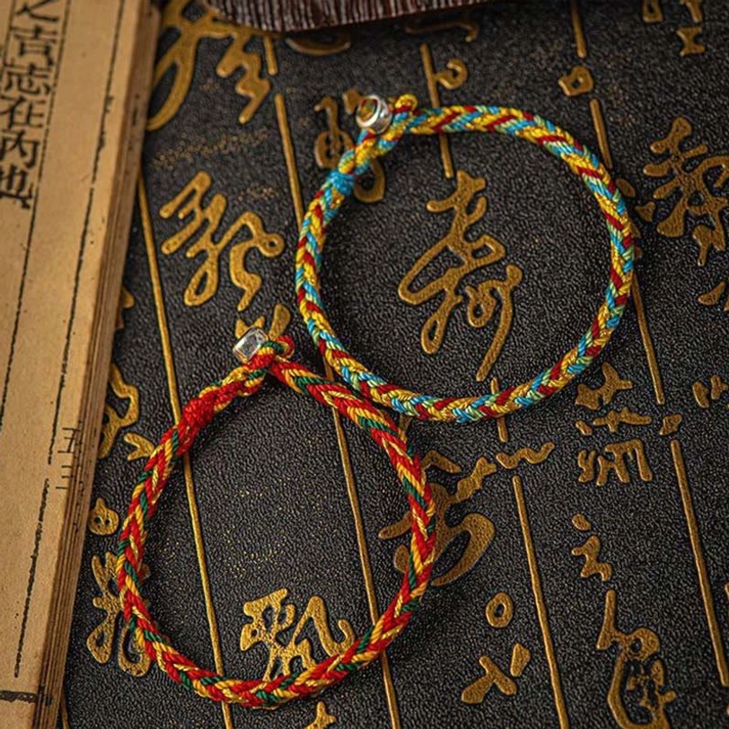 Two styles of Tibetan multicolor protection bracelets with silver clasps displayed together