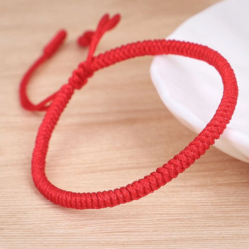 Tibetan King Kong knot protection bracelet detail shot showing sacred red string weaving and adjustable closure mechanism