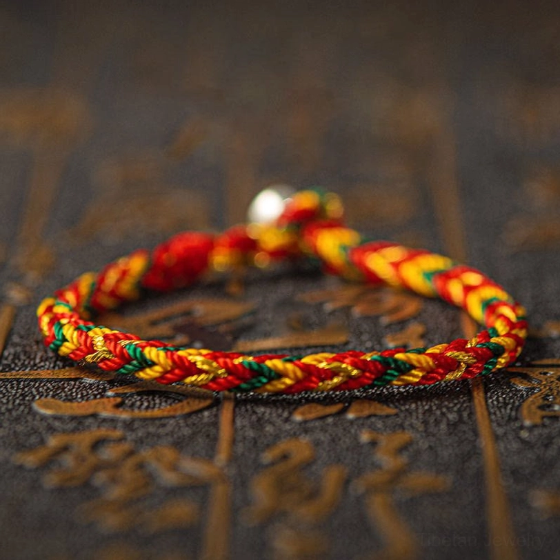 Tibetan protection bracelet orange-red-dark-green multicolor woven design