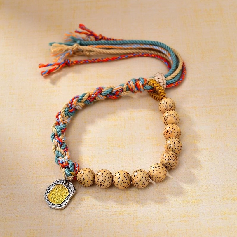Tibetan colored rope bracelet with Zakiram protection goddess pendant, showing adjustable design and hand-woven details