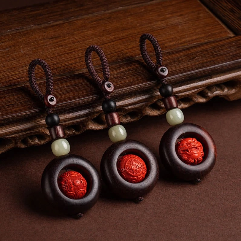 Tibetan Buddhist protective keychains with Om Mani Padme Hum carved cinnabar beads and red sandalwood flat lay arrangement