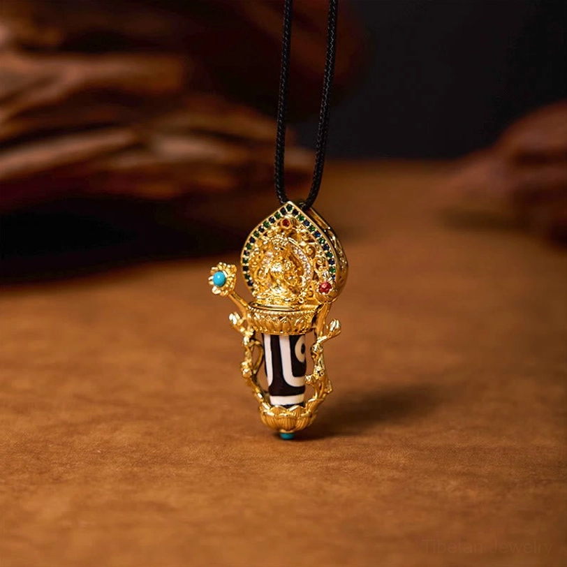 Tibetan protective Dzi bead necklace with detailed Buddha-style gold mount and turquoise accents, left side view