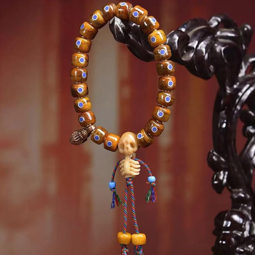 Tibetan skull bone protective bracelet with intricate beadwork and decorative skull charm on tassel