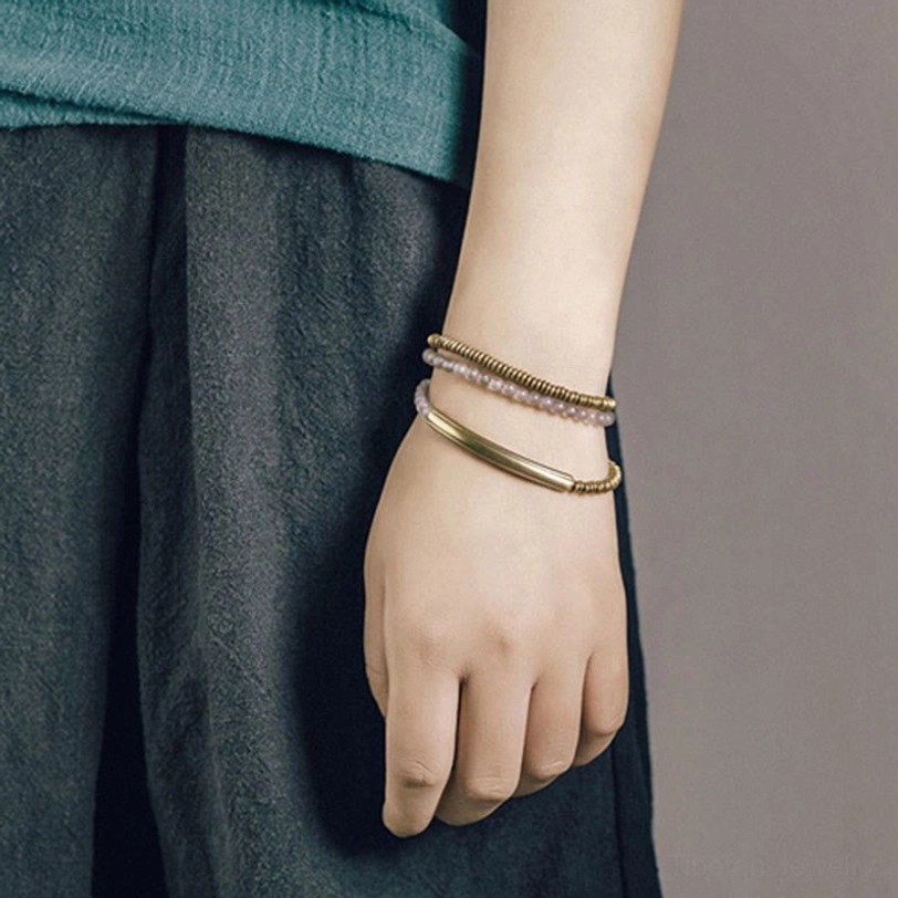 Tibetan red agate healing stone bracelet with traditional brass cuff showing protective energy properties