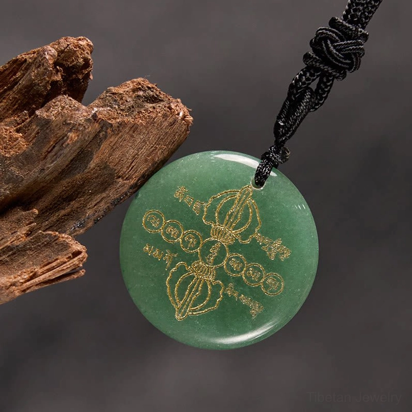 Red agate Vajra Dorje Tibetan necklace pendant featuring golden Sanskrit carvings and spiritual Dorje symbol