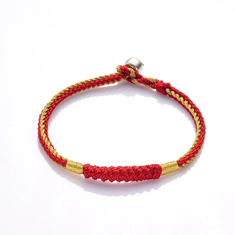 Tibetan red string protection bracelet with braided rope design and silver adjustable clasp on white background