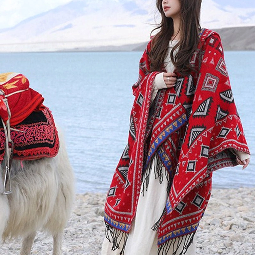 Red Tibetan ethnic poncho wrap with geometric tribal print and fringe trim, front view casual style