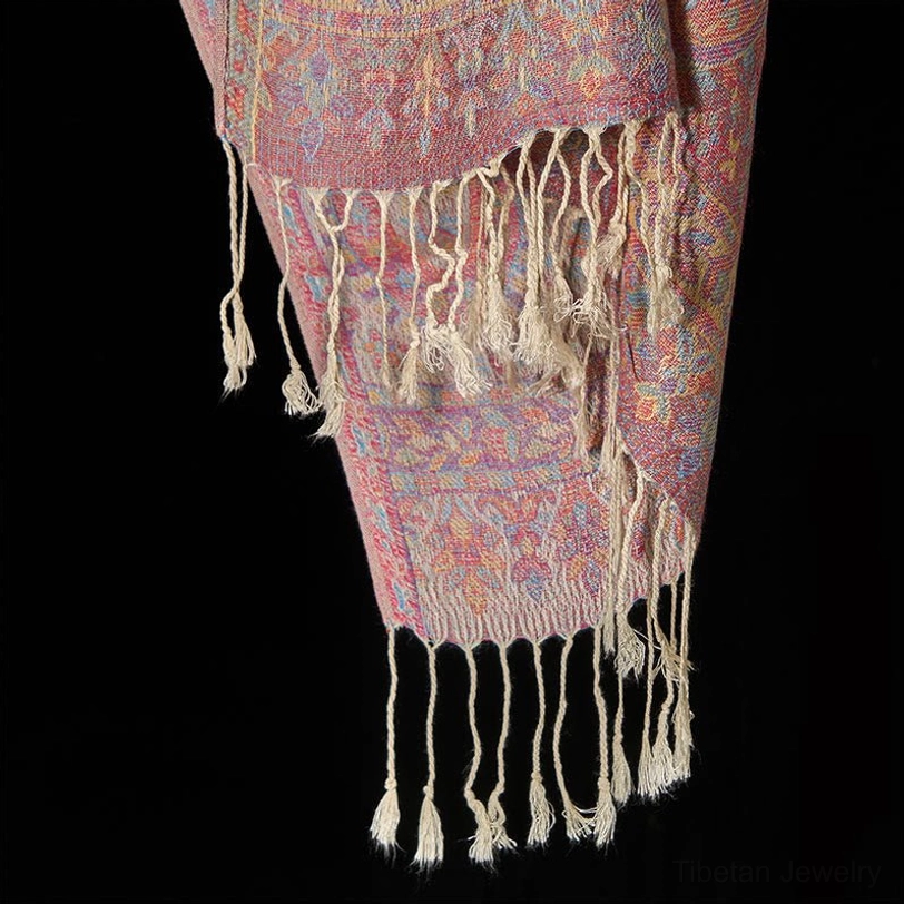Tibetan red paisley scarf with tassels laid flat, showing complete pattern design and color depth