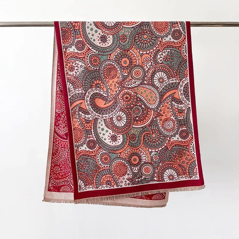 Red Tibetan ethnic paisley shawl with tassel fringe, reversible design featuring traditional geometric patterns and hand-woven borders