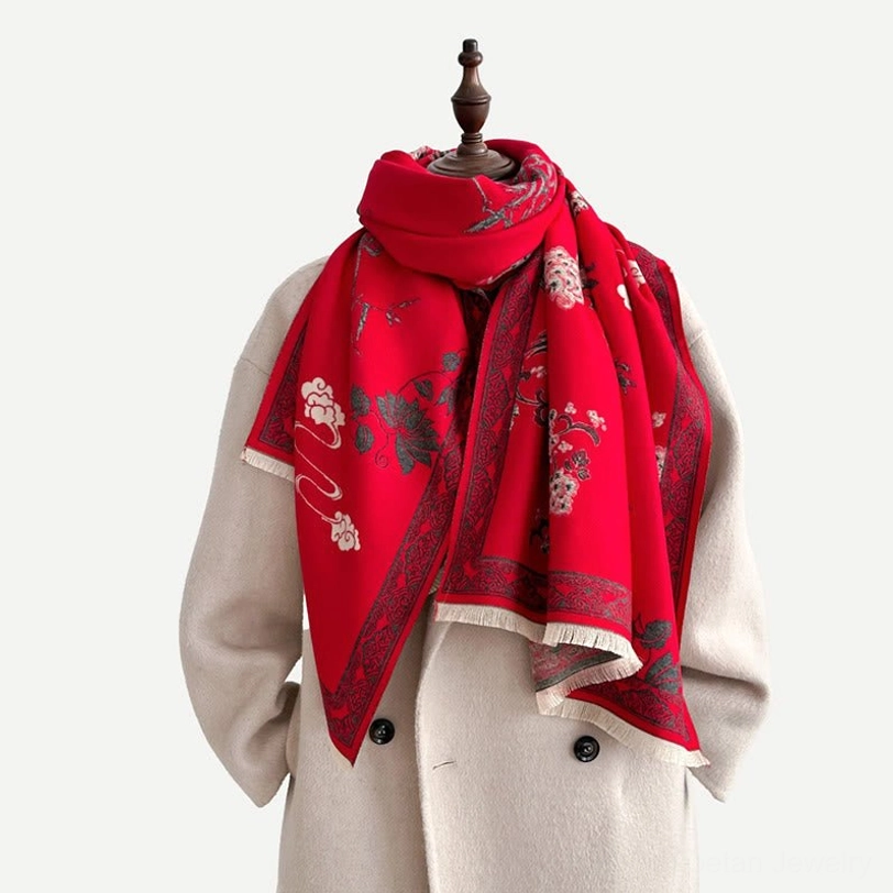 Red Tibetan scarf worn on mannequin front view showing floral bird pattern and fringed hem detail