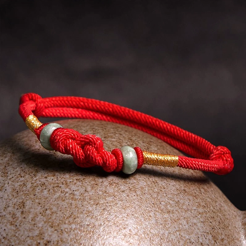 Red woven string jade bracelet with twisted knot and jade bead embellishments