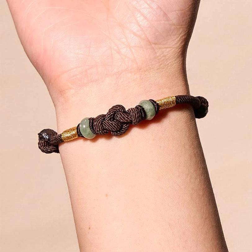 Red string jade lucky knot bracelet showing authentic handmade natural material texture