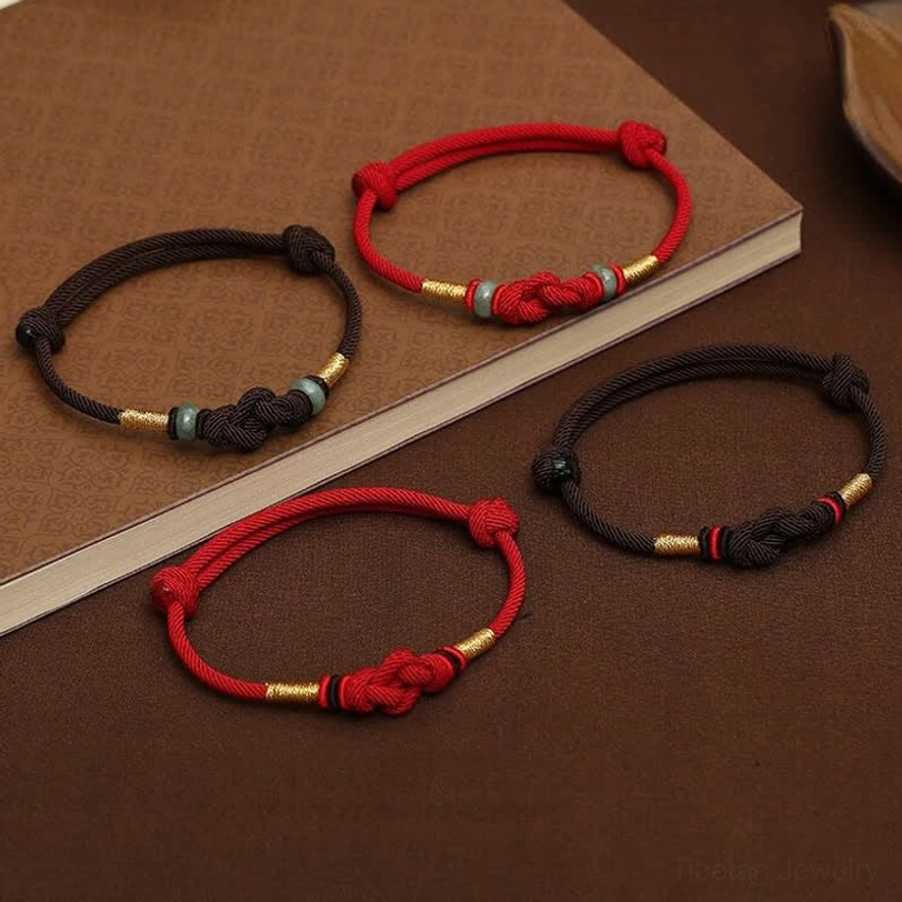 Tibetan jade lucky knot bracelet on elegant display showing spiritual aesthetic and design