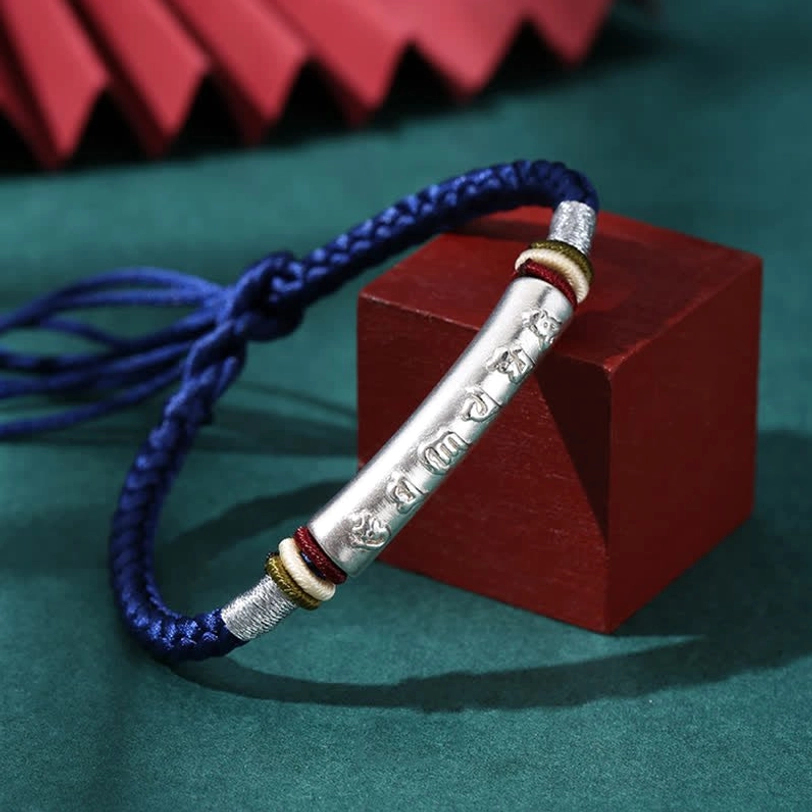 Tibetan red string protection bracelet with 999 sterling silver tube featuring sacred mantra