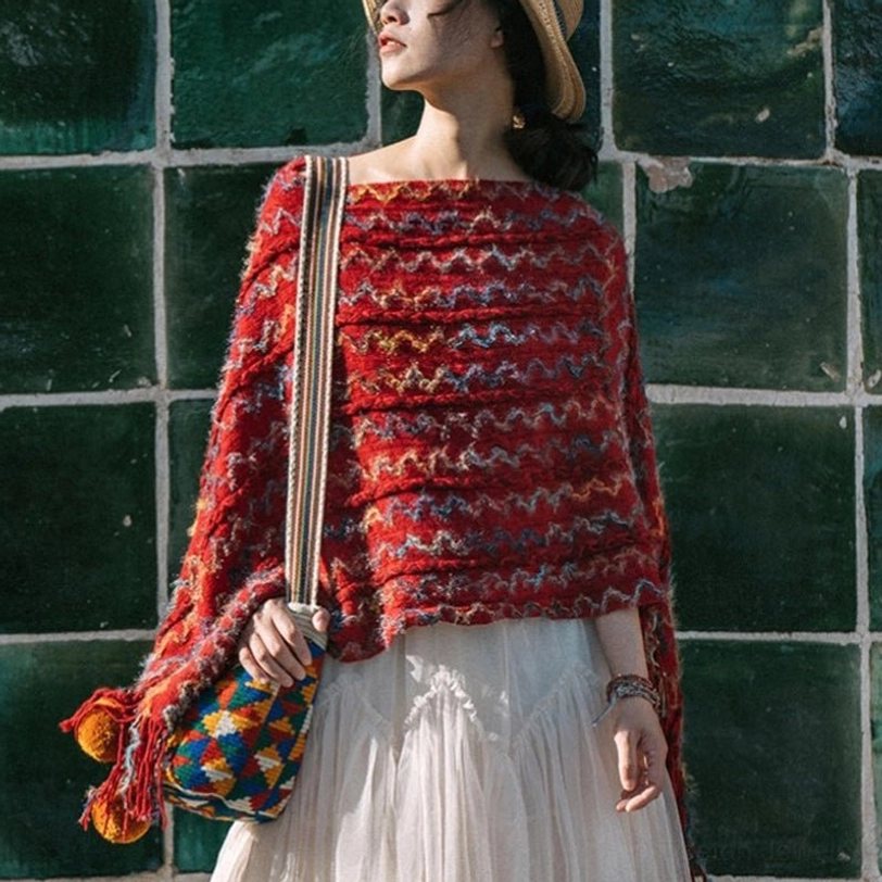 Red woven tibetan tassel wrap shawl with fringe edges paired with white tulle skirt on green ceramic wall background