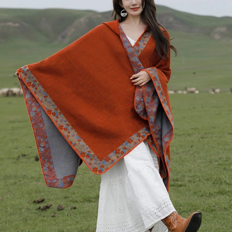 Reversible Tibetan poncho full side profile showing grey inner lining, walking pose on grassland pasture