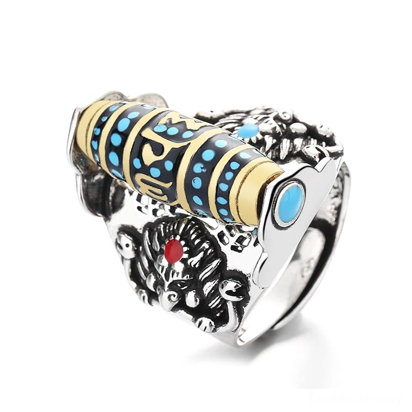 Tibetan Om Mani Padme Hum dzi ring bottom view displaying intricately carved Garuda pattern, blue enamel bead with red-blue gem inlays