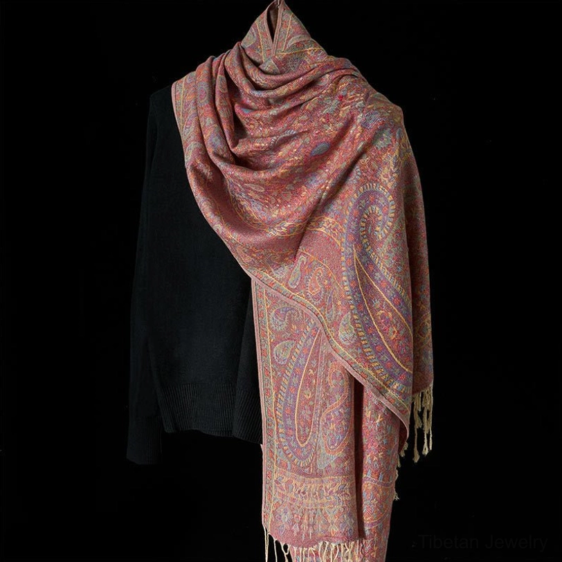 Three-quarter front draped view of Tibetan rose pink scarf showing soft woven texture and elegant styling
