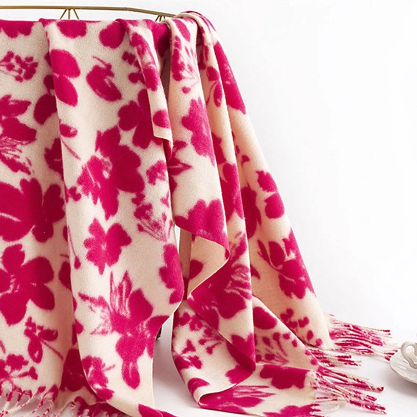 Rose red tibetan floral tassel shawl hung on rack showing draped fabric and shadow flower print