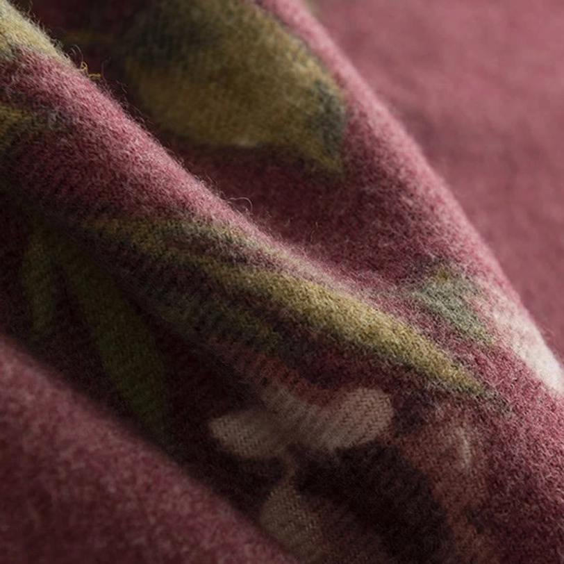Close-up macro view of Tibetan rose shawl burgundy base with plush woven texture and detailed rose print