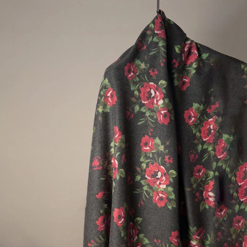 Close-up detail of Tibetan rose floral print on shawl showing thick woven cozy fabric texture