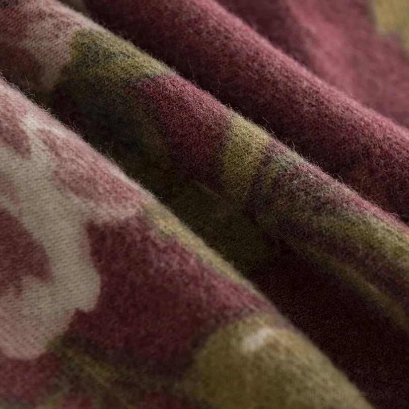 Macro close-up of Tibetan rose shawl showing vintage floral print detail with soft fabric drape and earthy palette
