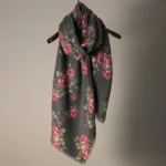 Tibetan rose floral printed shawl hanging on display, showing rich floral pattern and soft draped texture
