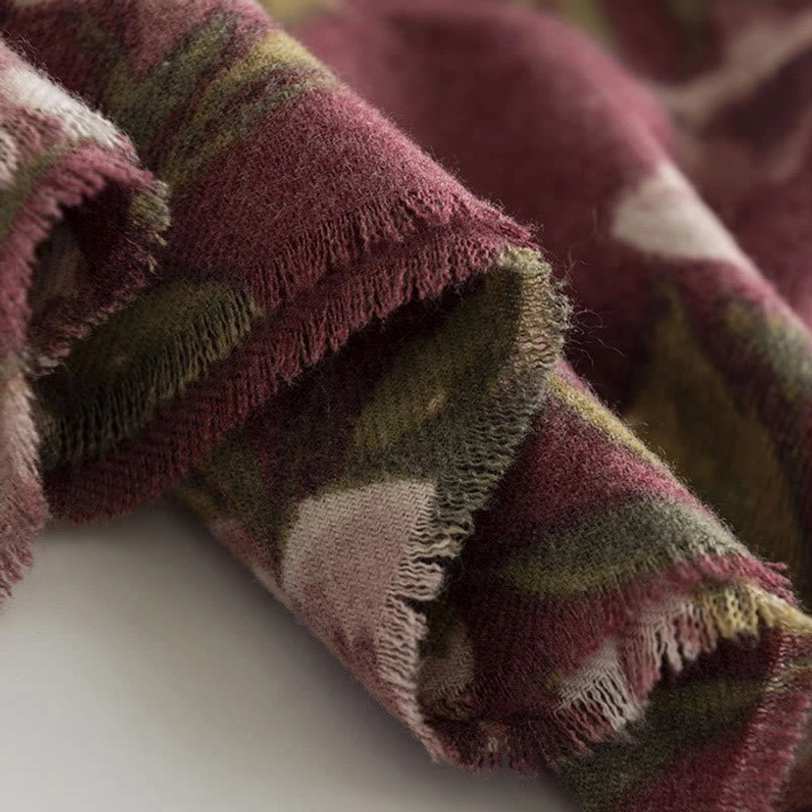 Tibetan rose shawl layered over cozy setting demonstrating versatile wear options and soft plush texture