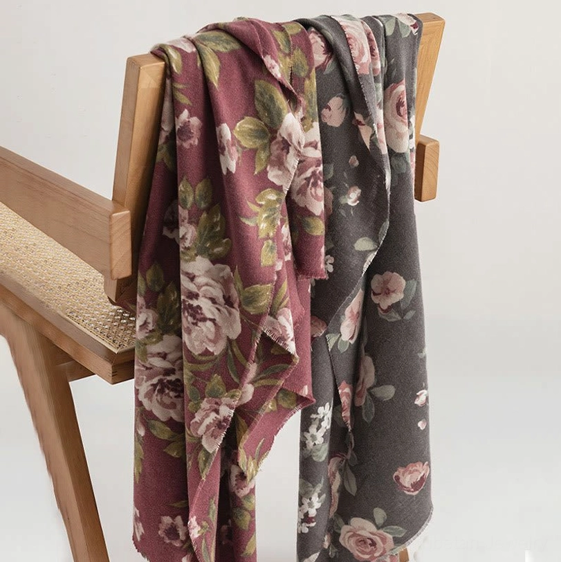 Tibetan rose shawls with floral prints draped over wooden chair showing bohemian styling and fabric softness