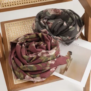Two Tibetan rose shawls rolled overhead view showing both burgundy and dim gray color variants with detailed rose patterns