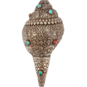 Sacred shankha conch shell with eight auspicious symbols engraving, direct front view on white background showing intricate Buddhist religious carvings