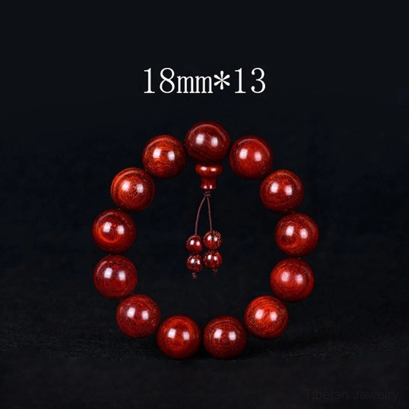 Close-up detail of Tibetan red sandalwood mala beads showing natural grain and warm reddish-brown color variations