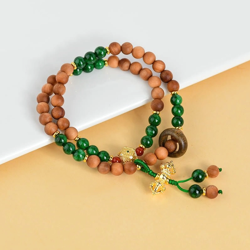 Double twisted sandalwood bead bracelet with green stone accents and gold dorje charm