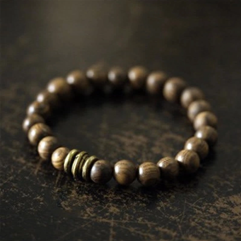 Tibetan sandalwood protection bracelet with natural wooden beads and bronze spacer rings, handcrafted meditation jewelry for healing and spiritual protection