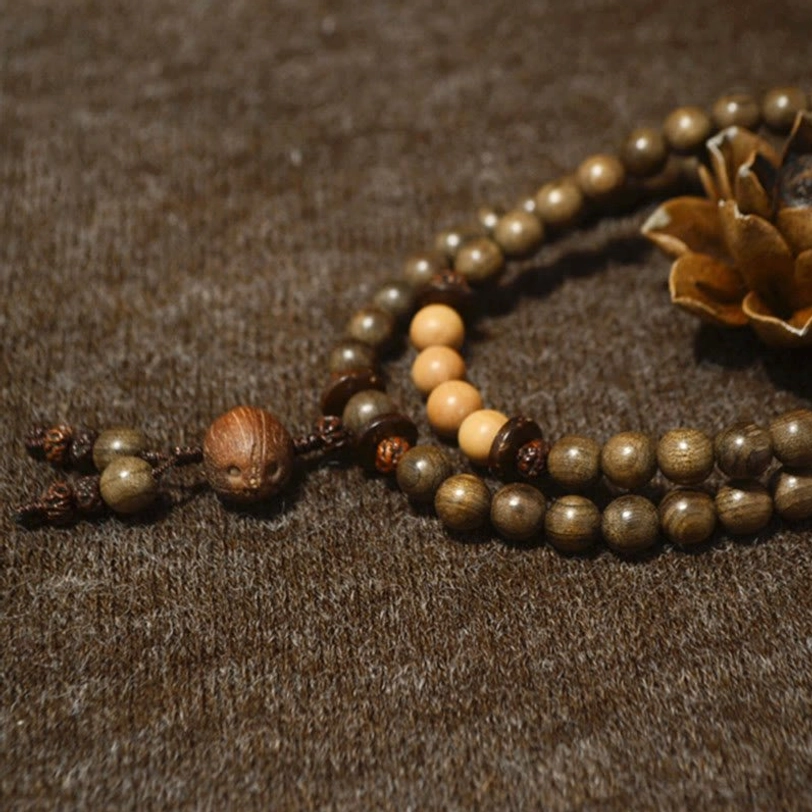 Long Tibetan sandalwood prayer bead mala with two-tone wooden beads and decorative tassel pendant