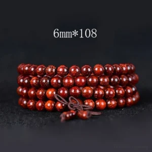 6mm bead Tibetan red sandalwood mala bracelet with 108 beads and traditional brown tassel, flat lay photography