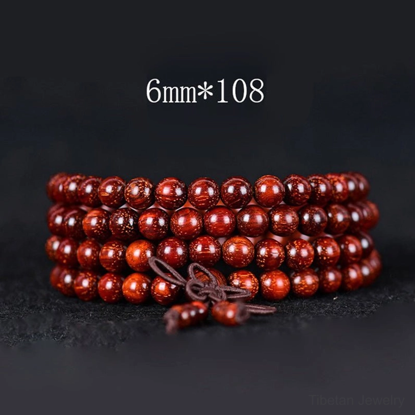 6mm bead Tibetan red sandalwood mala bracelet with 108 beads and traditional brown tassel, flat lay photography