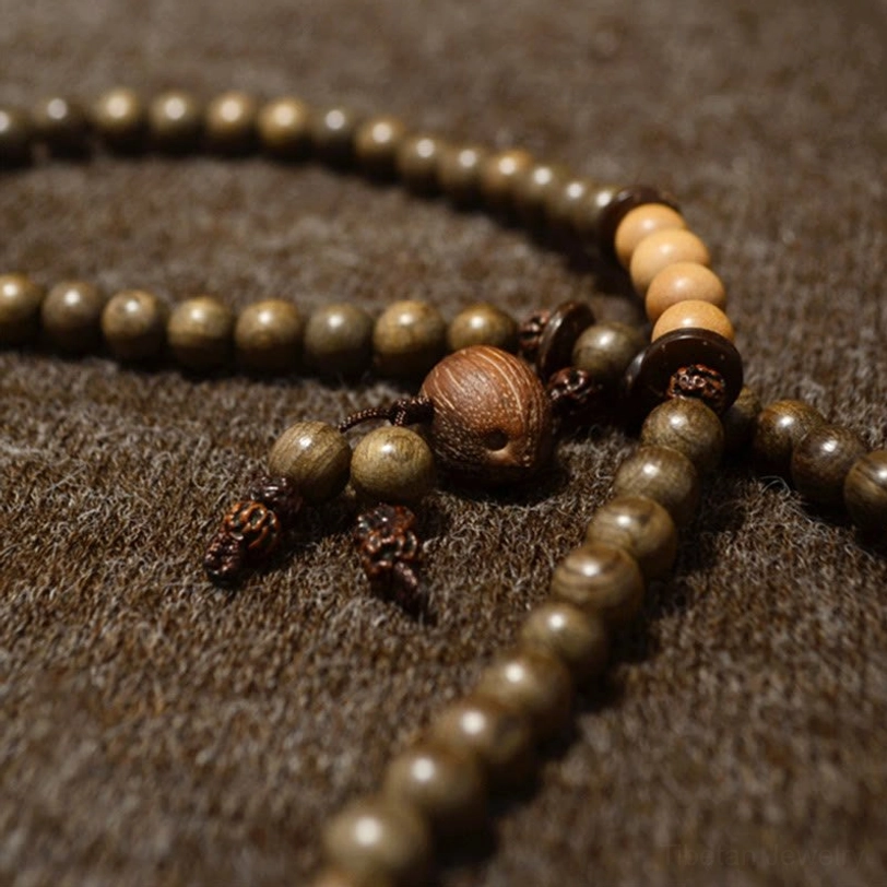Double-strand Tibetan sandalwood mala with varied wooden beads and large central pendant with tassels