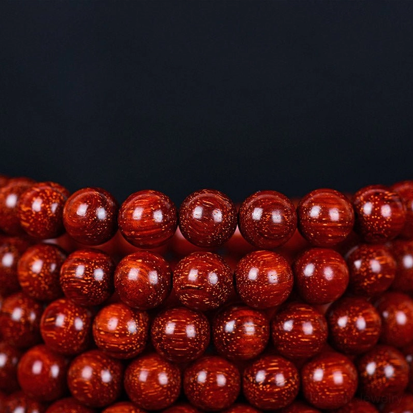 Tibetan red sandalwood mala bracelet flat lay photography showing full 108 bead circle and proportions